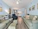 Inviting living room with cozy sofas, beach-themed decor, and an open view of the kitchen at 5000 N Ocean Blvd. # B-1, North Myrtle Beach, SC 29582