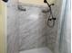 Modern shower with marble-like tiles and black fixtures at 5000 N Ocean Blvd. # B-1, North Myrtle Beach, SC 29582