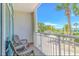 Balcony featuring outdoor seating and a view of the pool area, palm trees, and ocean at 5300 N Ocean Blvd. # 106, Myrtle Beach, SC 29577