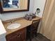 Bathroom vanity with granite countertop, dark wood cabinet, and illuminated makeup mirror at 5300 N Ocean Blvd. # 106, Myrtle Beach, SC 29577