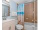 Bathroom featuring a single sink vanity, tiled shower with curtain and beach themed decor at 5300 N Ocean Blvd. # 106, Myrtle Beach, SC 29577