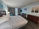 Bedroom with a king-size bed, ocean-themed decor, and private balcony access at 5300 N Ocean Blvd. # 106, Myrtle Beach, SC 29577