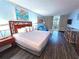 Bedroom featuring a large bed, modern decor, and sliding glass door to a balcony at 5300 N Ocean Blvd. # 106, Myrtle Beach, SC 29577