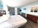 Bedroom with a king-size bed, ocean-themed decor, and private balcony access at 5300 N Ocean Blvd. # 106, Myrtle Beach, SC 29577