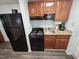 Compact kitchen with wood cabinets, granite countertops and appliances, offering functionality at 5300 N Ocean Blvd. # 106, Myrtle Beach, SC 29577