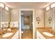 Bright bathroom featuring double sinks, granite counters, and an open shower area at 5300 N Ocean Blvd. # 922, Myrtle Beach, SC 29572