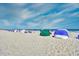 Wide sandy beach with colorful beach tents under a clear blue sky at 5300 N Ocean Blvd. # 922, Myrtle Beach, SC 29572