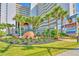 Beautifully landscaped entrance to the condo buildings with lush greenery and colorful flowers at 5300 N Ocean Blvd. # 922, Myrtle Beach, SC 29572