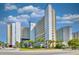 Exterior view of the condo buildings with lush landscaping and a beautifully designed entrance at 5300 N Ocean Blvd. # 922, Myrtle Beach, SC 29572
