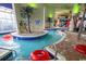 Indoor lazy river with tropical-themed decor, red tubes and clear water, creating a relaxing aquatic environment at 5300 N Ocean Blvd. # 922, Myrtle Beach, SC 29572