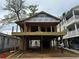 Under-construction home featuring a two-story design with wood framing and a raised foundation showcasing its potential at 6001 - 5142 S Kings Hwy., Myrtle Beach, SC 29575