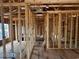 Hallway view under construction highlighting wood framing, exposed beams, and electrical wiring, illustrating the home's construction progress at 6001 - 5142 S Kings Hwy., Myrtle Beach, SC 29575