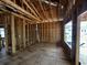 Interior view of a room under construction, emphasizing the wood framing, exposed beams, and electrical and plumbing elements at 6001 - 5142 S Kings Hwy., Myrtle Beach, SC 29575