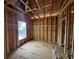 Under-construction room featuring wood framing, a window, and plywood subflooring, offering a glimpse of the home's potential at 6001 - 5142 S Kings Hwy., Myrtle Beach, SC 29575
