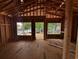 Unfinished living room featuring wood frame construction, subfloor, windows, and an open doorway to outside at 6001 - 5142 S Kings Hwy., Myrtle Beach, SC 29575