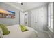 Bright bedroom showcasing an open bathroom door and a large closet with white bi-fold doors at 756 Waterbridge Blvd., Myrtle Beach, SC 29579