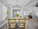 A dining area featuring a modern chandelier with table and chairs, connecting to the living room at 756 Waterbridge Blvd., Myrtle Beach, SC 29579
