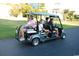 Golf cart with passengers riding along a paved path, suggesting convenient transportation and a leisurely lifestyle within the community at 756 Waterbridge Blvd., Myrtle Beach, SC 29579
