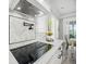 Close up of kitchen cooktop with modern vent hood and backsplash, as well as dining area at 756 Waterbridge Blvd., Myrtle Beach, SC 29579