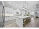 Spacious kitchen with a large island, pendant lighting, and modern white cabinetry at 756 Waterbridge Blvd., Myrtle Beach, SC 29579