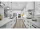 A modern white kitchen with an island, stainless steel appliances, and stylish pendant lighting at 756 Waterbridge Blvd., Myrtle Beach, SC 29579