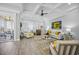 Living room with tray ceiling, modern furniture, and seamless flow to dining and kitchen areas at 756 Waterbridge Blvd., Myrtle Beach, SC 29579