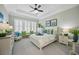 Bright main bedroom with tray ceilings, decorative pillows, shutters, and ample natural light at 756 Waterbridge Blvd., Myrtle Beach, SC 29579