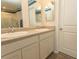 Bathroom with double vanity, two mirrors, and door on the right at 884 Freestyle Ct., Longs, SC 29568