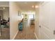 Inviting hallway featuring stylish wood-look floors leading to an open-concept living area at 884 Freestyle Ct., Longs, SC 29568