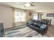 Open living room featuring neutral walls, ceiling fan, and slider to backyard at 884 Freestyle Ct., Longs, SC 29568