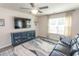 Inviting living room featuring a ceiling fan, modern decor, and ample natural light at 884 Freestyle Ct., Longs, SC 29568