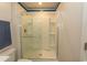 Bright bathroom with shower featuring clear sliding doors and built-in shelves at 884 Freestyle Ct., Longs, SC 29568
