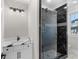 Modern bathroom featuring black marble shower with glass door, black fixtures and granite vanity at 100 Serenity Point Dr., Little River, SC 29566