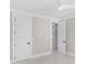 Bright bedroom with white wood-look floors, modern door design, and recessed lighting at 100 Serenity Point Dr., Little River, SC 29566