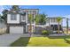 Beautifully designed modern home with a stone facade, manicured lawn, and a two-car garage at 100 Serenity Point Dr., Little River, SC 29566
