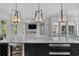 Modern kitchen featuring marble countertop island, pendant lights, stainless steel appliances, and open access to the living room at 100 Serenity Point Dr., Little River, SC 29566