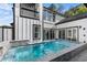 Backyard pool with modern tile accents, a waterfall feature and view of the second story balcony at 100 Serenity Point Dr., Little River, SC 29566