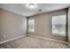 Neutral bedroom with two windows providing natural light and neutral carpeting throughout at 104 Barnacle Ln. # 3, Little River, SC 29566