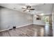 Bright living room with modern flooring, a ceiling fan, and an open layout leading into the kitchen area at 104 Barnacle Ln. # 3, Little River, SC 29566