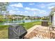 Lovely backyard with a grill and patio set overlooking a peaceful lake and well-maintained lawn at 1046 Palisade Circle # 1046, Myrtle Beach, SC 29577