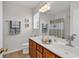 Bathroom featuring a double sink vanity, modern lighting, and a decorative mirror at 1046 Palisade Circle # 1046, Myrtle Beach, SC 29577