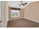 Cozy bedroom featuring neutral colors, a ceiling fan, and a window overlooking a serene lake at 1046 Palisade Circle # 1046, Myrtle Beach, SC 29577
