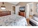 Well-lit bedroom with neutral colors, complemented by a TV, dresser, and comfortable seating area at 1046 Palisade Circle # 1046, Myrtle Beach, SC 29577