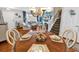 Comfortable dining area adjacent to the living room, featuring a decorative chandelier and staircase to the second level at 1046 Palisade Circle # 1046, Myrtle Beach, SC 29577