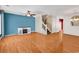 Spacious living room with hardwood floors, fireplace, and stairs leading to the upper level at 1046 Palisade Circle # 1046, Myrtle Beach, SC 29577