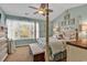 Relaxing primary bedroom with light blue walls and a four poster bed across from the window at 1046 Palisade Circle # 1046, Myrtle Beach, SC 29577