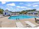 Community pool featuring lounge chairs and umbrellas with a clubhouse in the background at 1046 Palisade Circle # 1046, Myrtle Beach, SC 29577