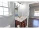 Bathroom featuring vanity with sink, window, and mirror with lights at 107 Carolines Cove Ct., Myrtle Beach, SC 29588