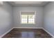 Bedroom with wood floors, neutral paint, and natural light through a large window at 107 Carolines Cove Ct., Myrtle Beach, SC 29588