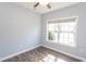 Well-lit bedroom with wood flooring, neutral paint, and a view of the front yard at 107 Carolines Cove Ct., Myrtle Beach, SC 29588